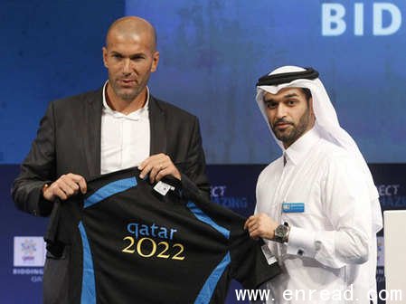 ceo of the qatar 2022 bid committee hassan al-thawadi (r) presents new official ambassador zinedine zidane with a personalised shirt in doha september 16, 2010. 