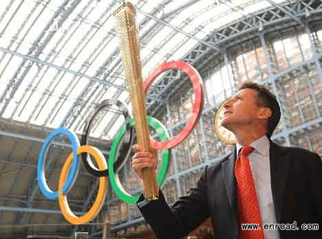 golden triangle: london 2012 chairman lord coe holds the three-cornered torch aloft as he unveils the design