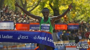 geoffrey mutai crosses the line in a course record for the new york marathon.