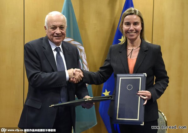 eu foreign policy chief federica mogherini (r) shakes hands with arab league chief nabil al-arabi as they sign a <a href=